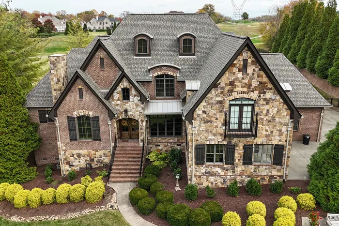 Full-Round Downspouts — 6" K-style seamless aluminum gutters with full-round downspouts installed by Three Stone in Middle Tennessee