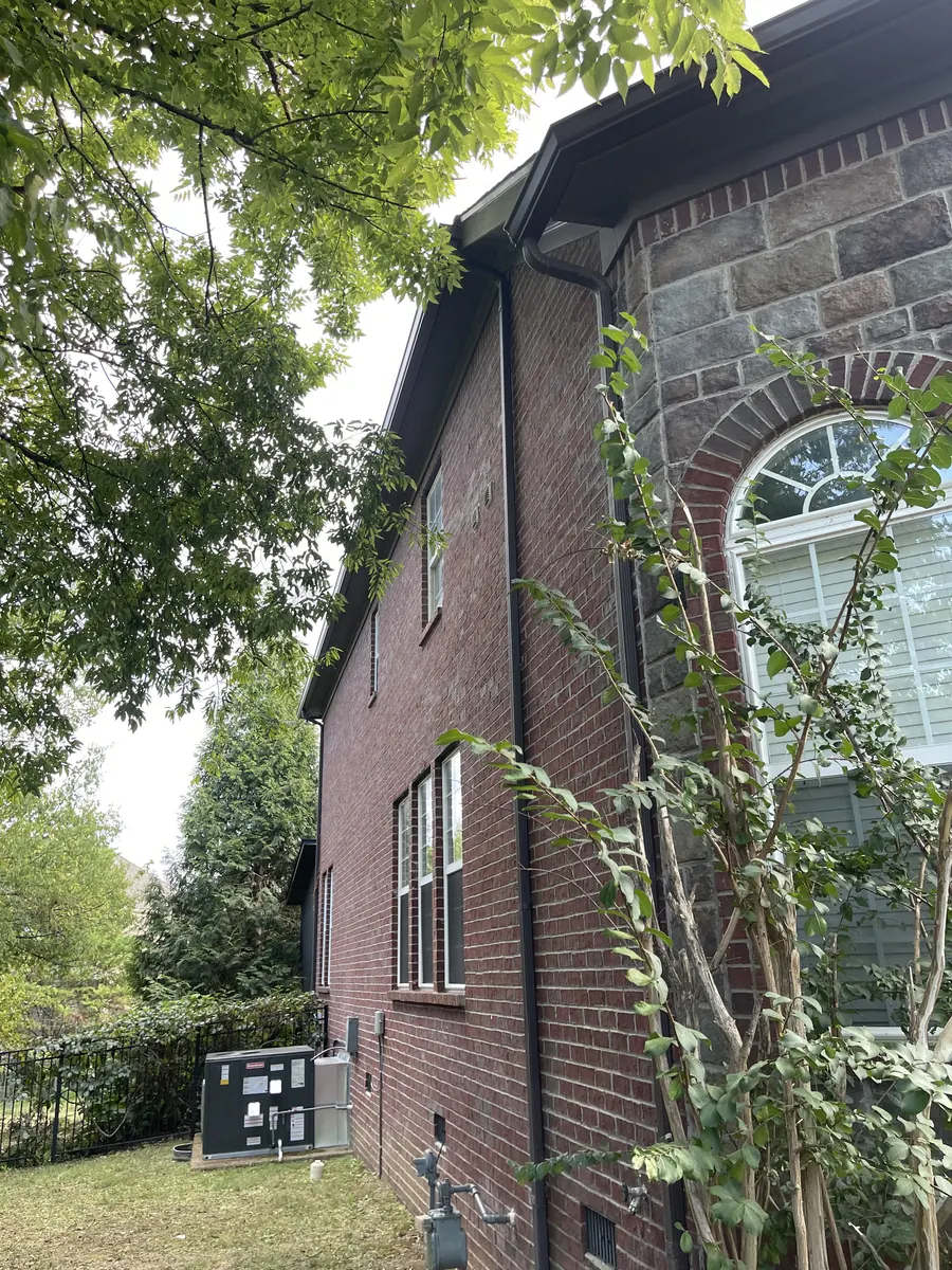Red Brick Home, Spectra K-Style — Spectra Metals 6" K-style gutters and downspouts by Three Stone in Middle Tennessee