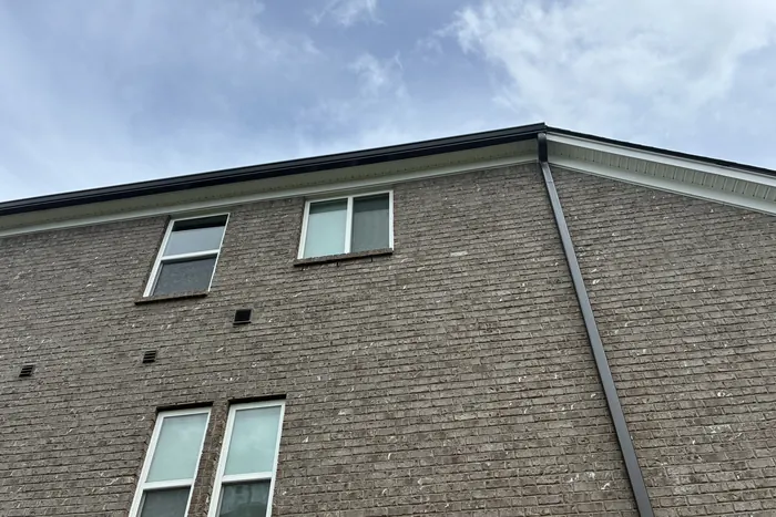 Tan Brick Home, Spectra K-Style — Spectra Metals 6" K-style gutters and downspouts installed by Three Stone in Middle Tennessee