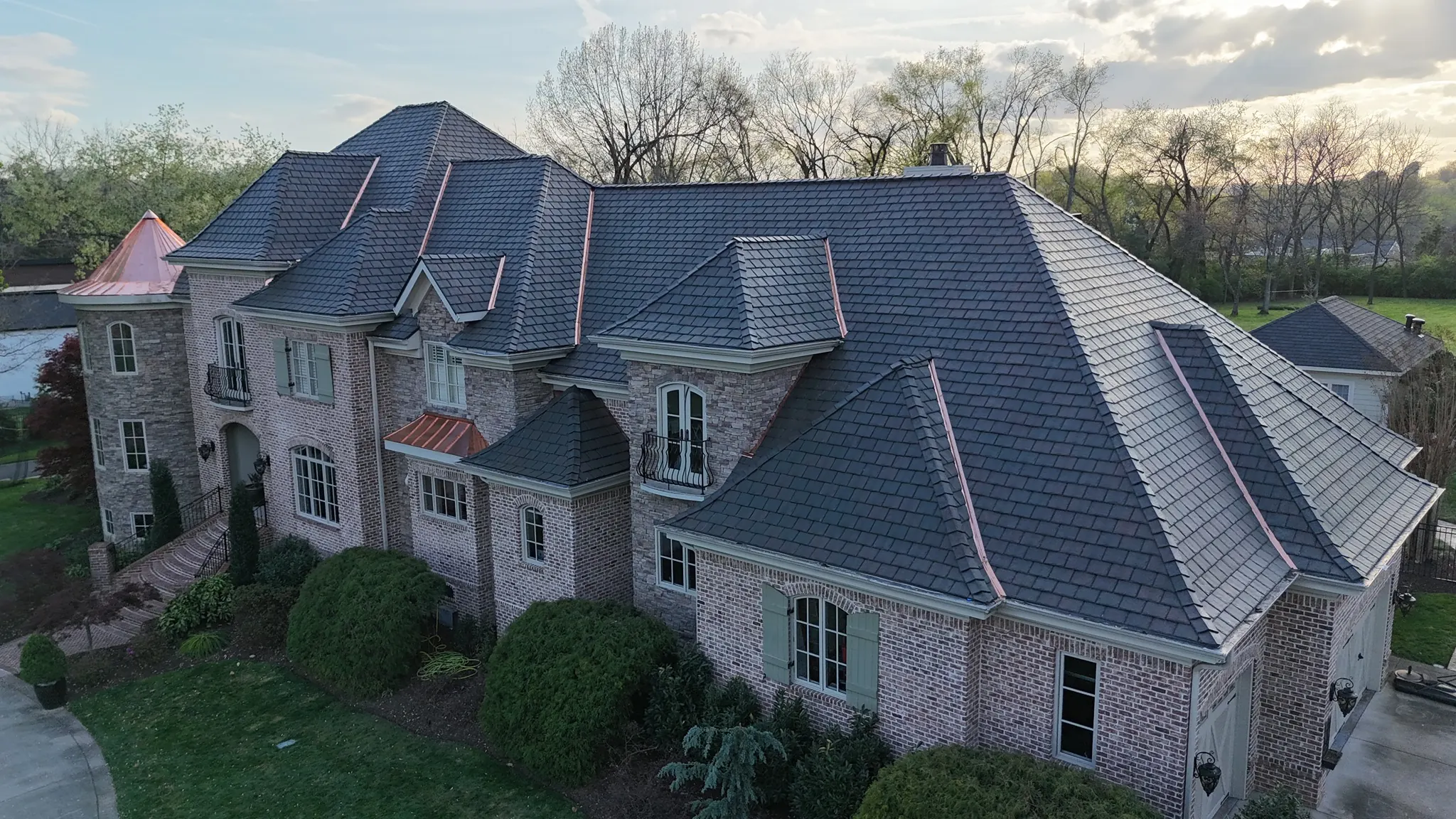 Aerial view of a Middle Tennessee estate with a new designer shake roof and copper accents installed by Three Stone