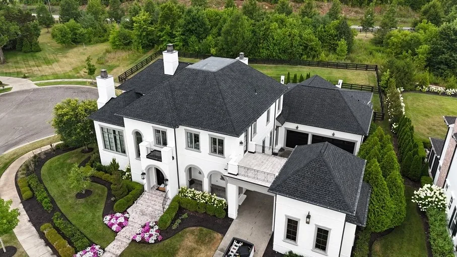 Aerial view of a white colonial home in Franklin, TN, roofed by Three Stone