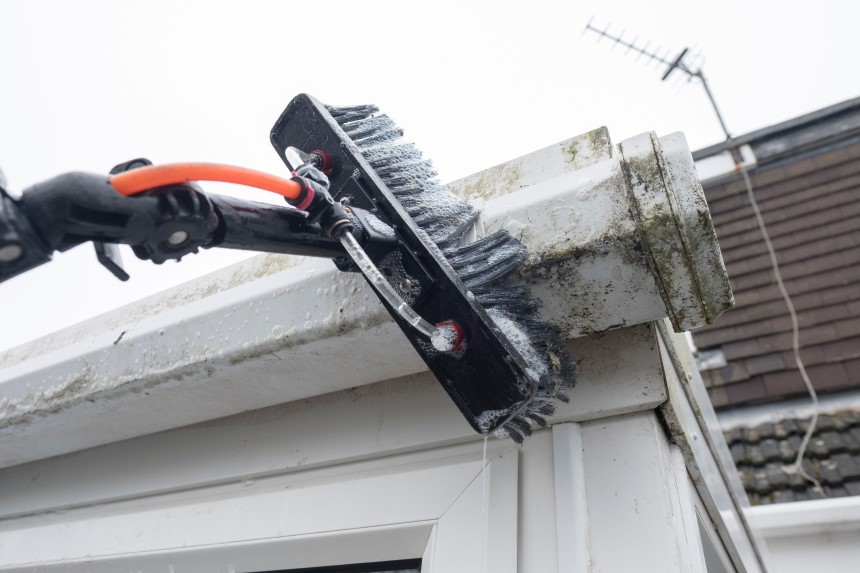 cleaning gutters with brush