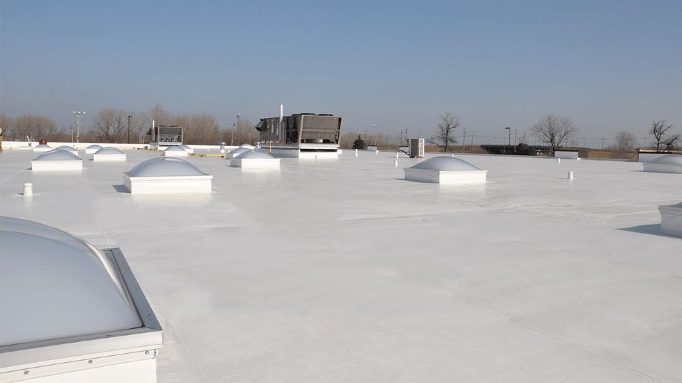 Aerial view of commercial building with a white rooftop