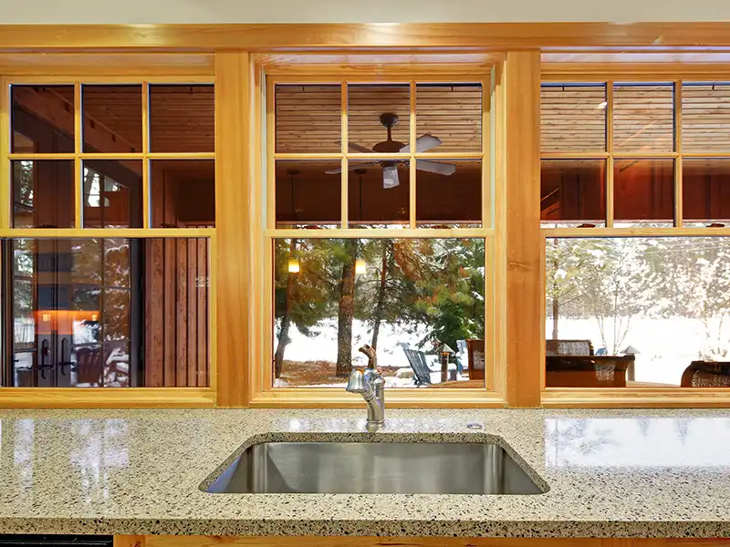 Low-angle view of windows on blue home