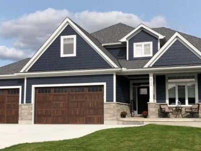 Front side of a blue mid-class home with vinyl James Haride siding